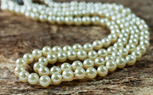 Close-up of pearl necklace on table