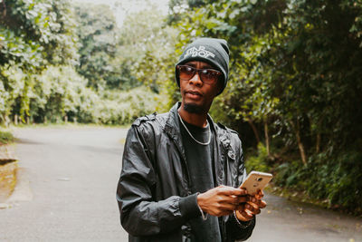 Portrait of young man using mobile phone