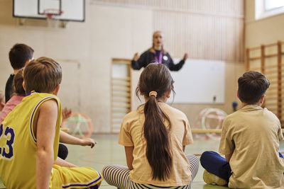 Children having class in school gym