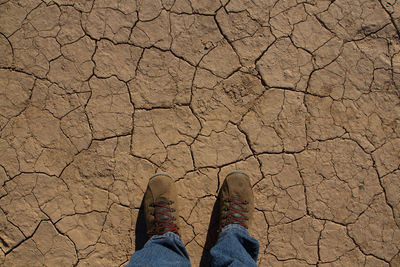 Low section of person standing on tiled floor