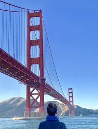 Rear view of golden gate bridge against sky