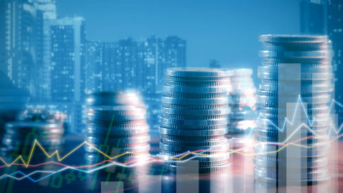 Digital composite image of illuminated buildings against sky at night