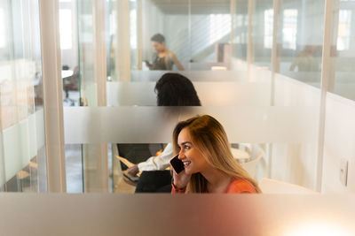 Business people talking over phone in office