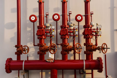 Close-up of red pipes against wall