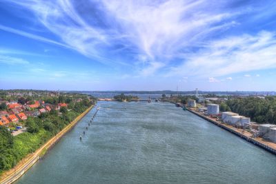 High angle view of river amidst city against sky