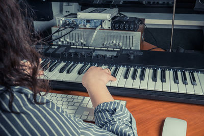 Low angle view of woman playing piano