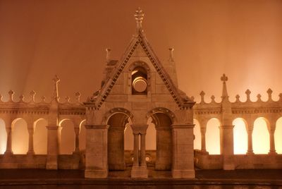 Low angle view of illuminated building against sky at night