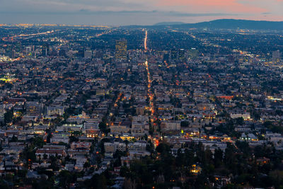 Aerial view of city buildings at dusk