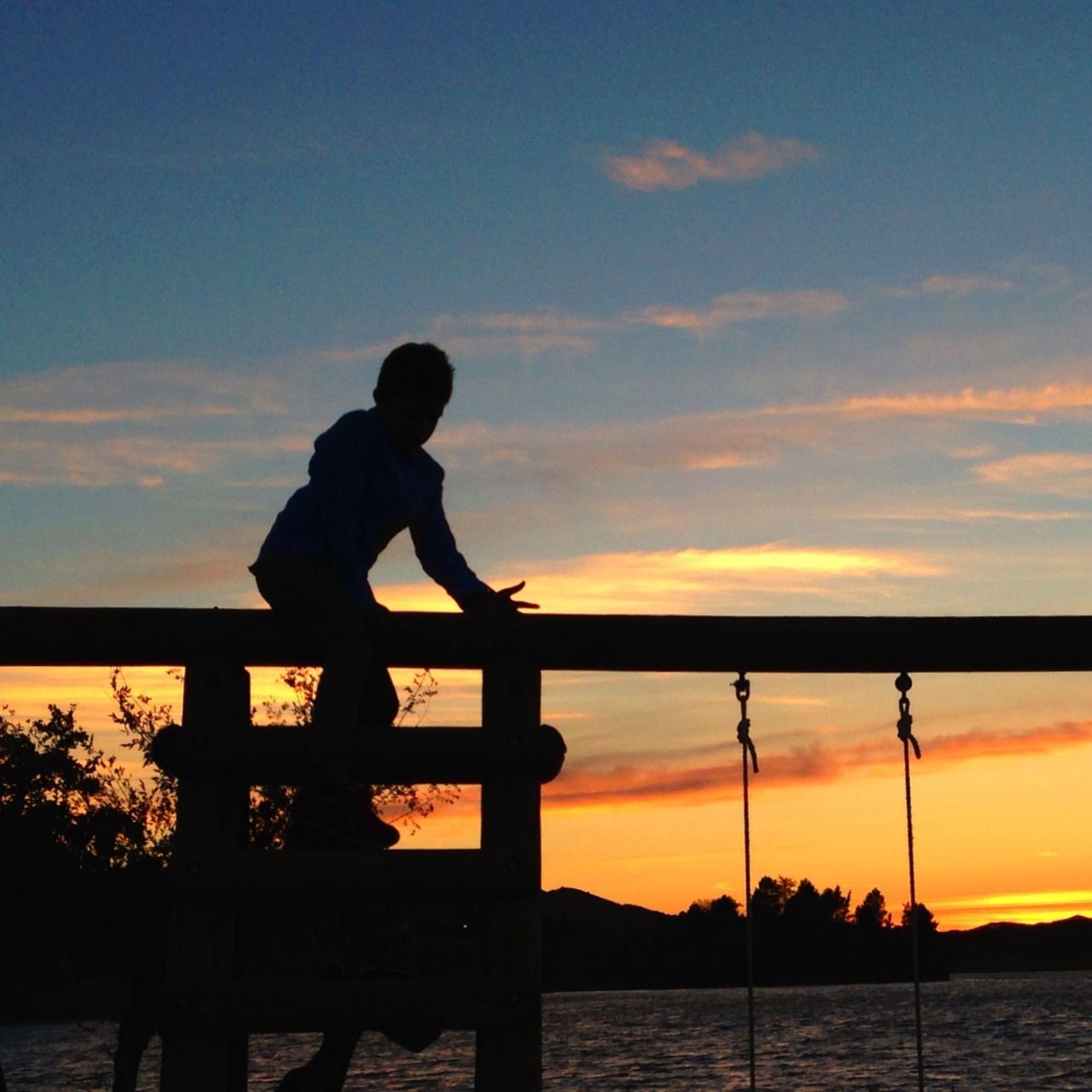 silhouette, sunset, water, sky, sea, orange color, leisure activity, lifestyles, men, standing, scenics, beauty in nature, tranquility, full length, tranquil scene, idyllic, horizon over water, nature