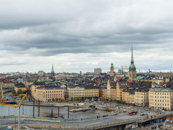 Cityscape against cloudy sky