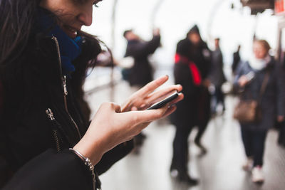 Midsection of woman using mobile phone