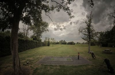 Scenic view of golf course against sky