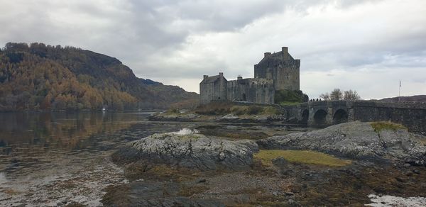 Buildings by rocks against sky