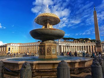 View of fountain in city against sky