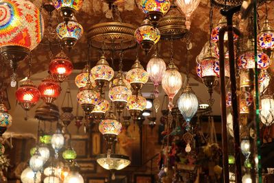 Low angle view of illuminated lanterns hanging at night