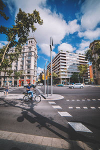 City street by buildings against sky