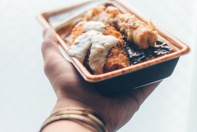 Close-up of hand holding ice cream in plate