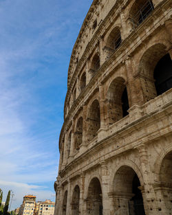 Low angle view of historical building colosseo against sky