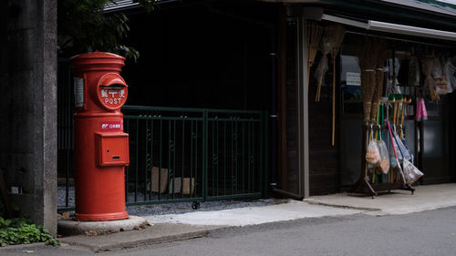 Red public mailbox at roadside