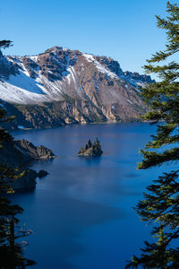Vertical image of the phantom ship in crater lake framed by trees
