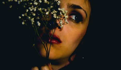 Woman holding flower at night