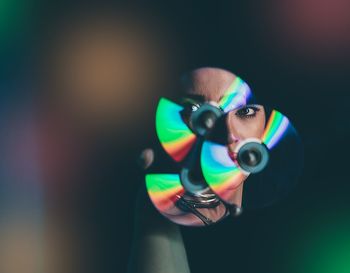 Reflection of woman seen in compact discs