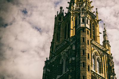 Low angle view of building against cloudy sky
