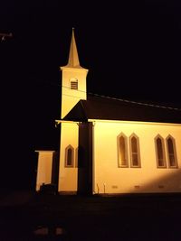 Low angle view of bell tower against sky at night