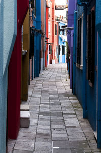 Empty alley amidst colorful buildings