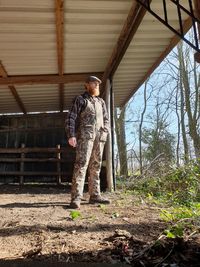 Full length of man standing by tree