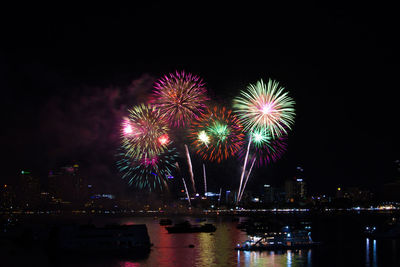Firework display in city at night