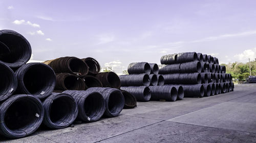 Stack of pipes against sky