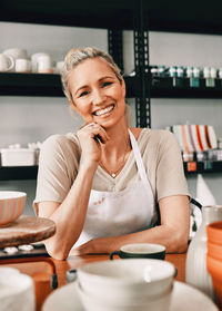 Portrait of young woman standing in workshop