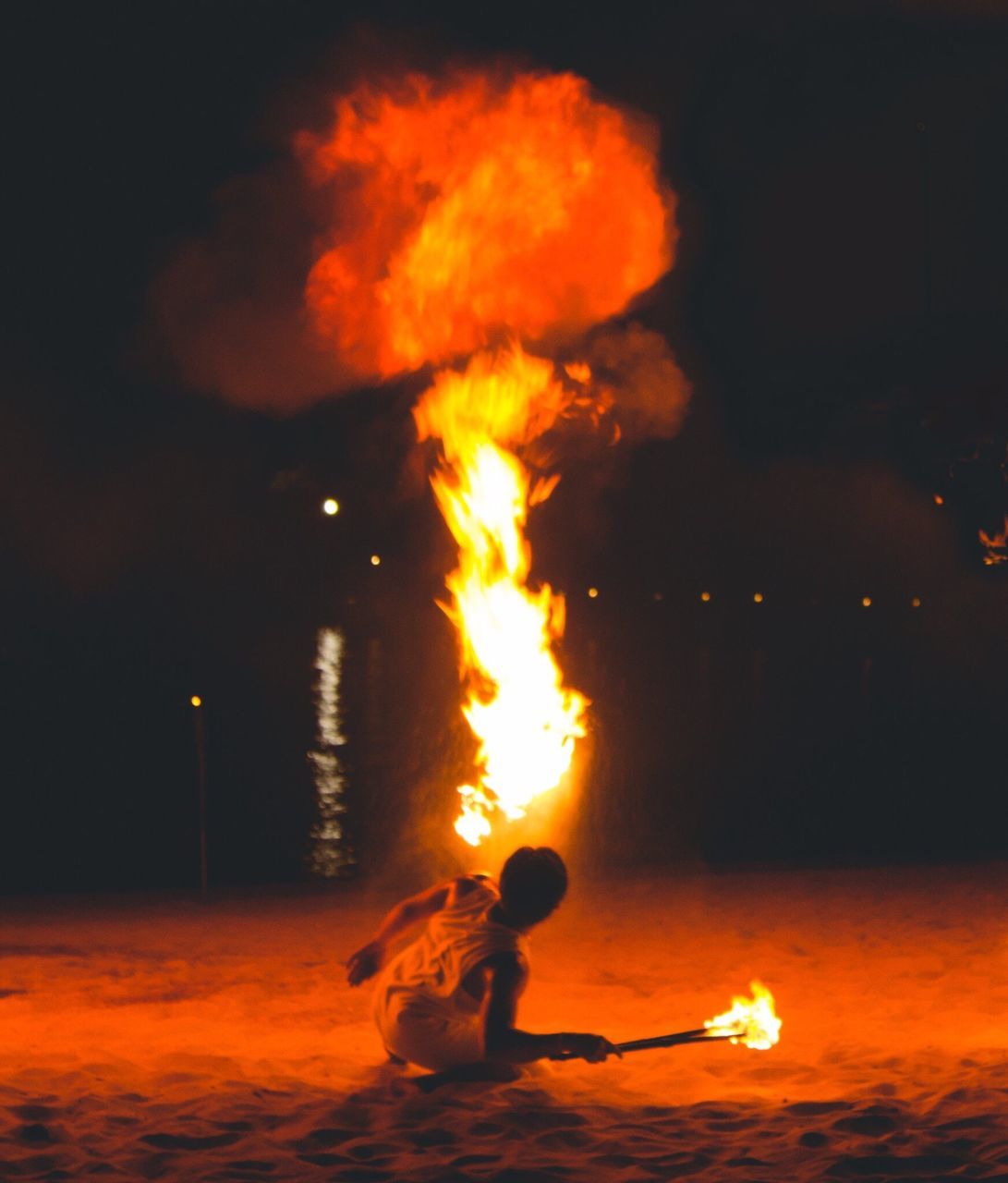 fire - natural phenomenon, flame, heat - temperature, burning, danger, exploding, full length, holding, outdoors, real people, people, one person, sky, night, nature, adult, adults only