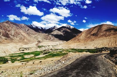 Scenic view of mountains against cloudy sky