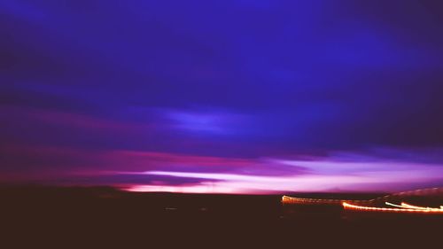 Silhouette landscape against sky at night