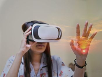 Woman gesturing while using virtual reality simulator