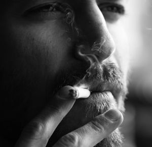 Close-up of young man smoking cigarette