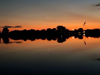 Scenic view of lake against sky at sunset