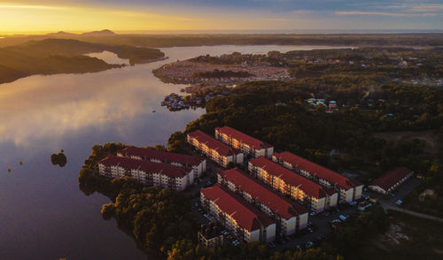 High angle view of buildings by sea against sky