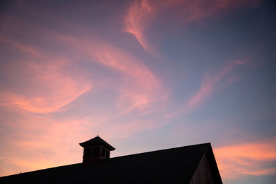 Low angle view of building against sky at sunset