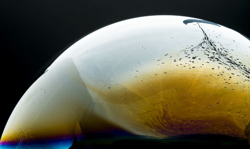 Extreme close-up of sphere against black background