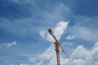 Low angle view of crane against sky