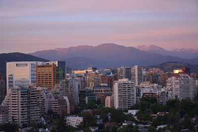 High angle view of buildings in city against sky during sunset