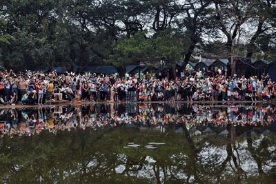 Panoramic view of people in lake