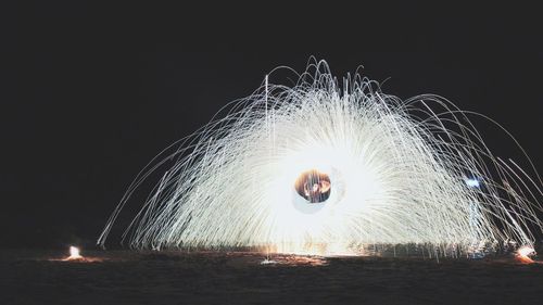 Firework display against sky at night