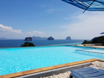 Scenic view of swimming pool by sea against sky