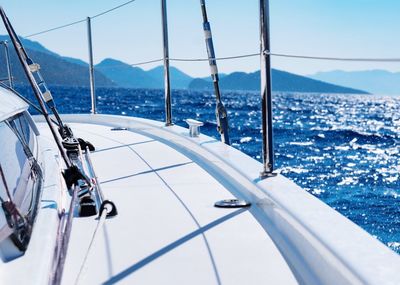 Sailboat sailing on sea against sky