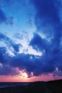 Scenic view of landscape against cloudy sky