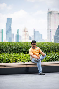 Portrait of smiling man sitting in garden